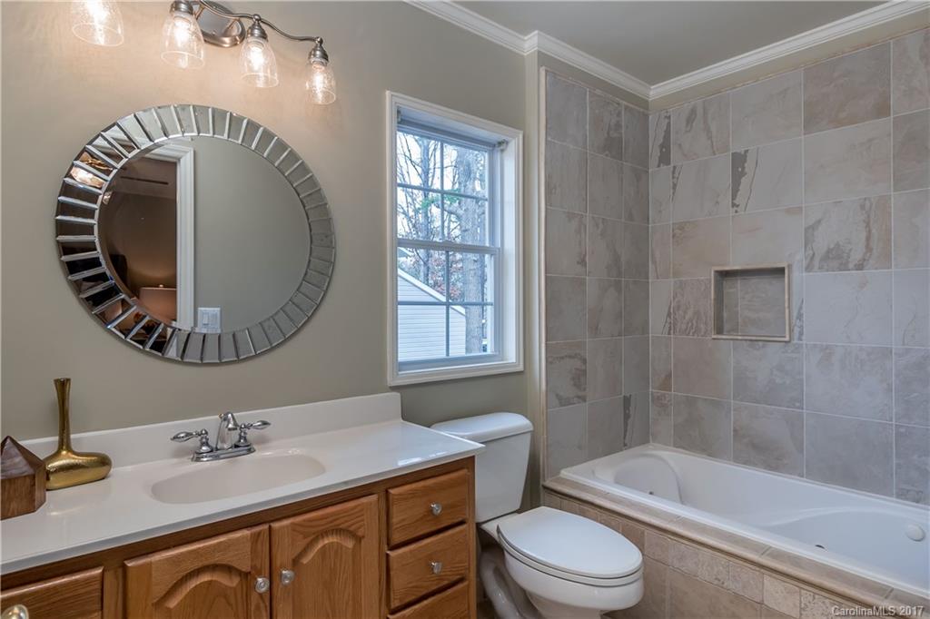 9300 Fairway Ridge Road Charlotte, NC 28277 - Photo 16 of 23 a bathroom with a sink a toilet and a mirror