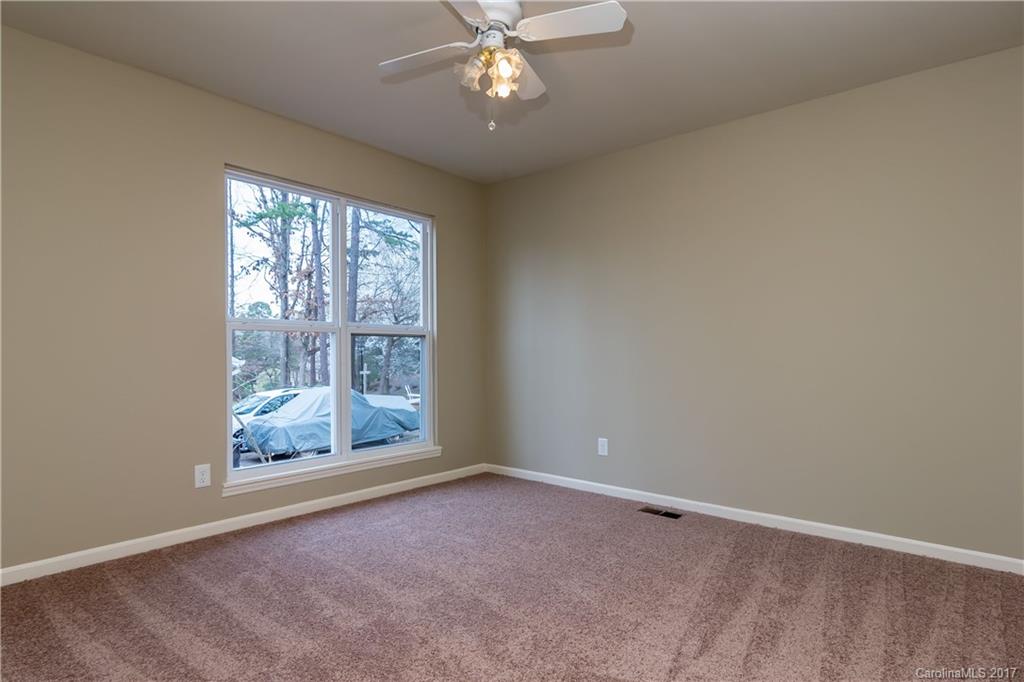 9300 Fairway Ridge Road Charlotte, NC 28277 - Photo 19 of 23 an empty room with windows and fan