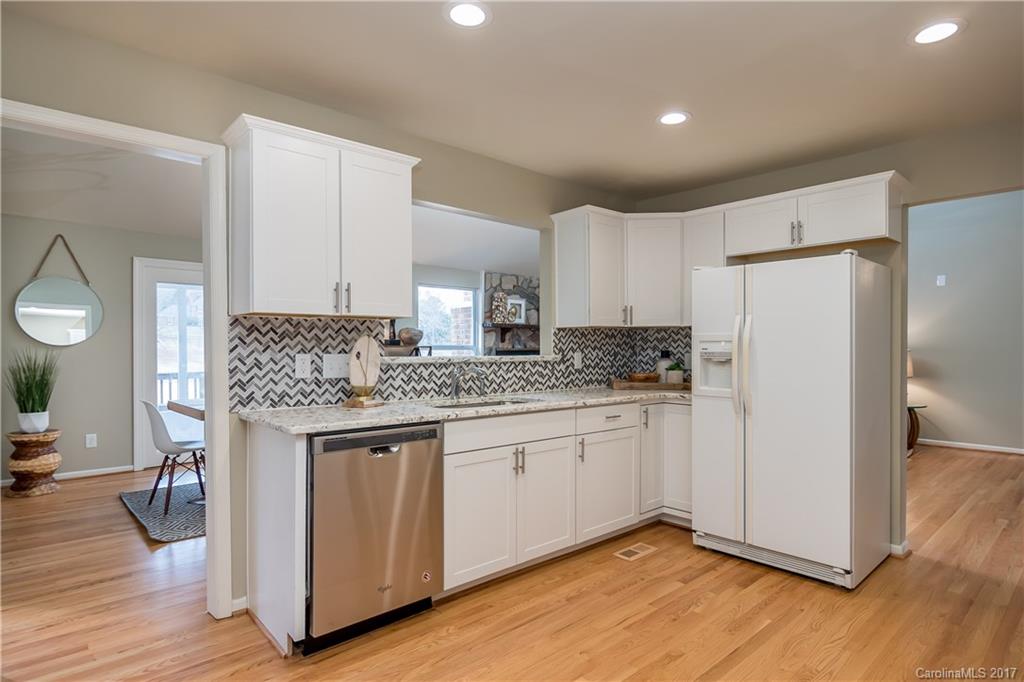 9300 Fairway Ridge Road Charlotte, NC 28277 - Photo 5 of 23 a kitchen with granite countertop white cabinets and white appliances