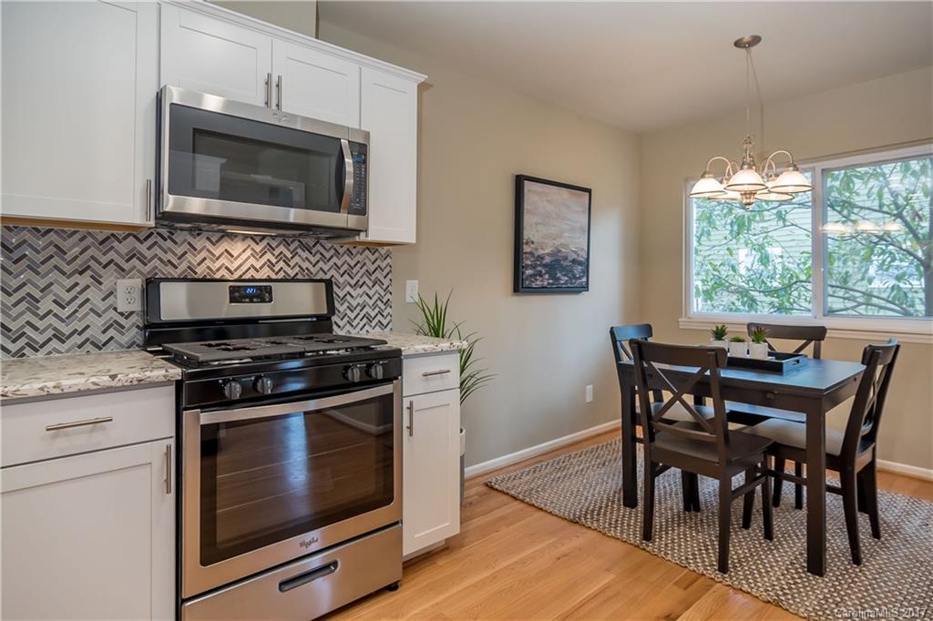 9300 Fairway Ridge Road Charlotte, NC 28277 - Photo 9 of 23 a kitchen with a stove a microwave and wooden floor