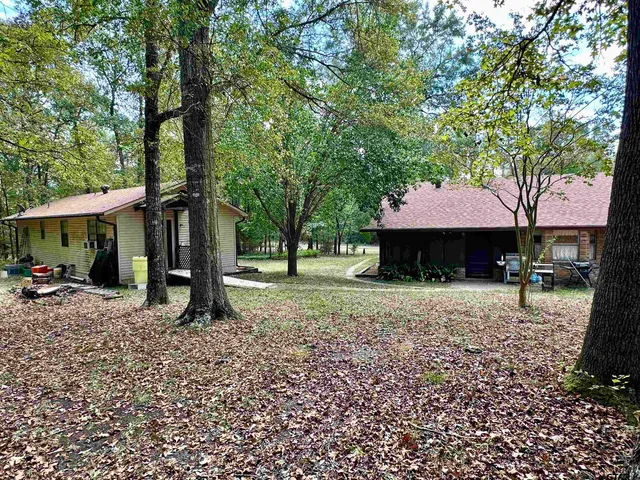 a house that has a tree in front of it