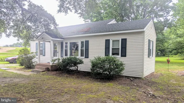 a view of a house with a yard and a garden