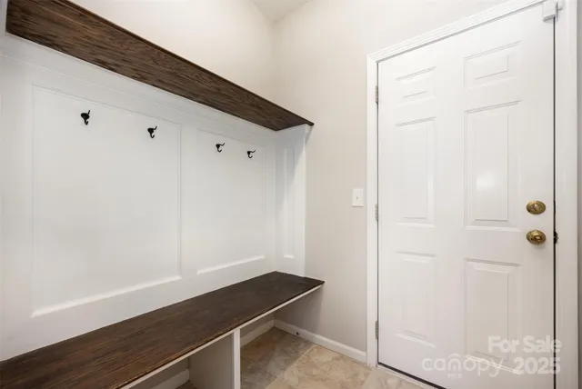 a kitchen with stainless steel appliances granite countertop a stove top oven a sink dishwasher and a refrigerator with wooden cabinets