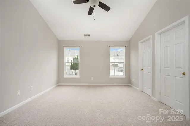 an empty room with windows and closet