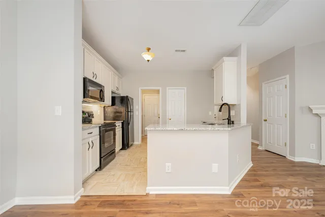 a large kitchen with cabinets and stainless steel appliances