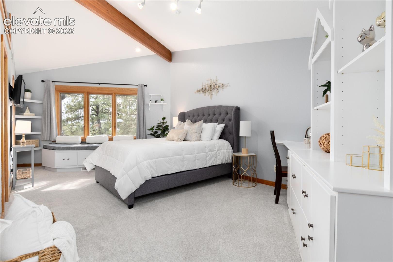 12730 Bridle Bit Road Colorado Springs, CO 80908 - Photo 18 of 48 Spacious bedroom with sitting bench in front of window