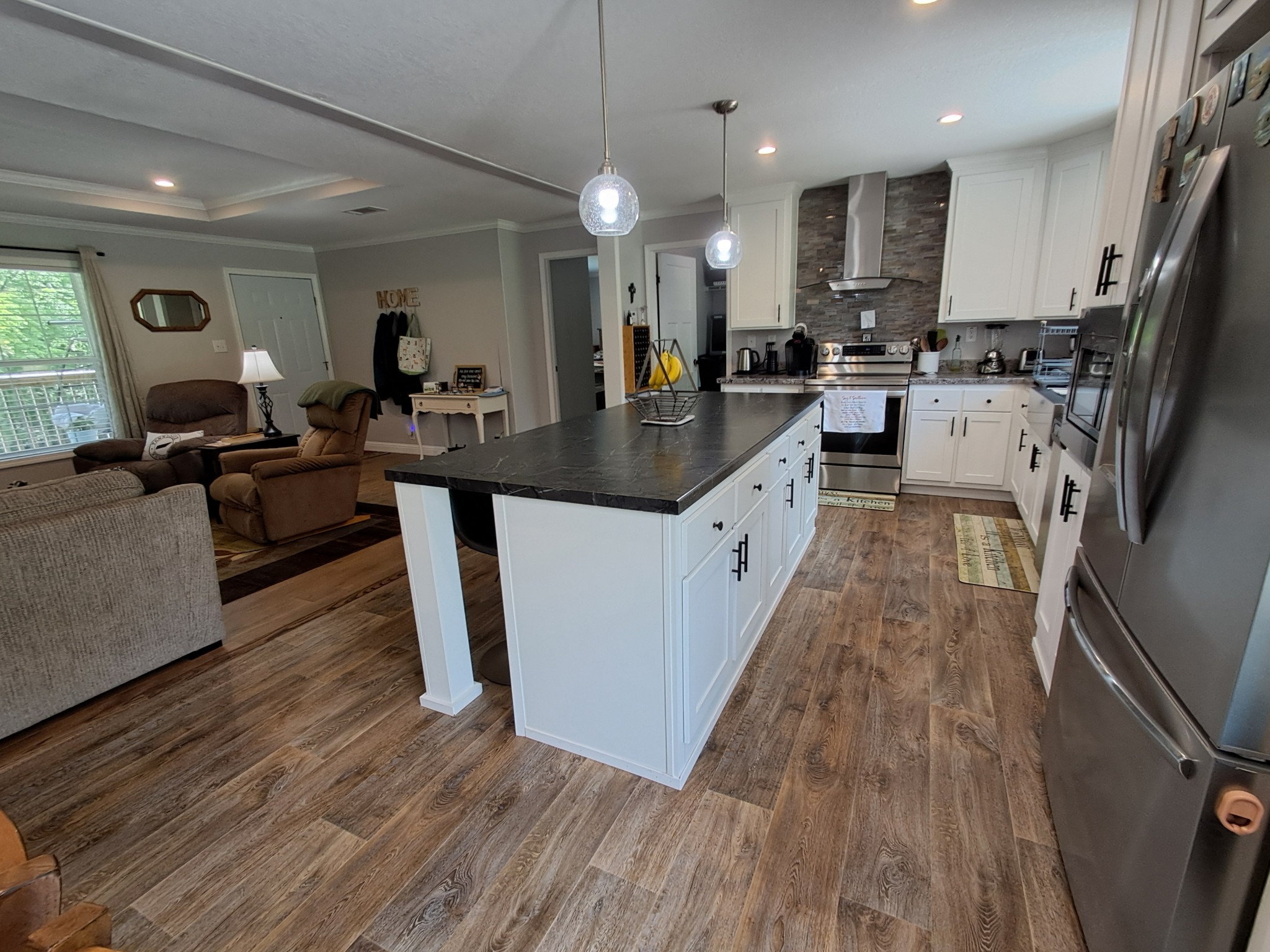 5525 Wiley Hollow Road Culleoka, TN 38451 - Photo 34 of 64 a large kitchen with stainless steel appliances kitchen island granite countertop a large counter top a sink dishwasher a refrigerator and wooden floor