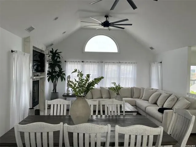 a living room with furniture a chandelier and a window