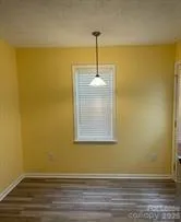 a view of an empty room and wooden floor