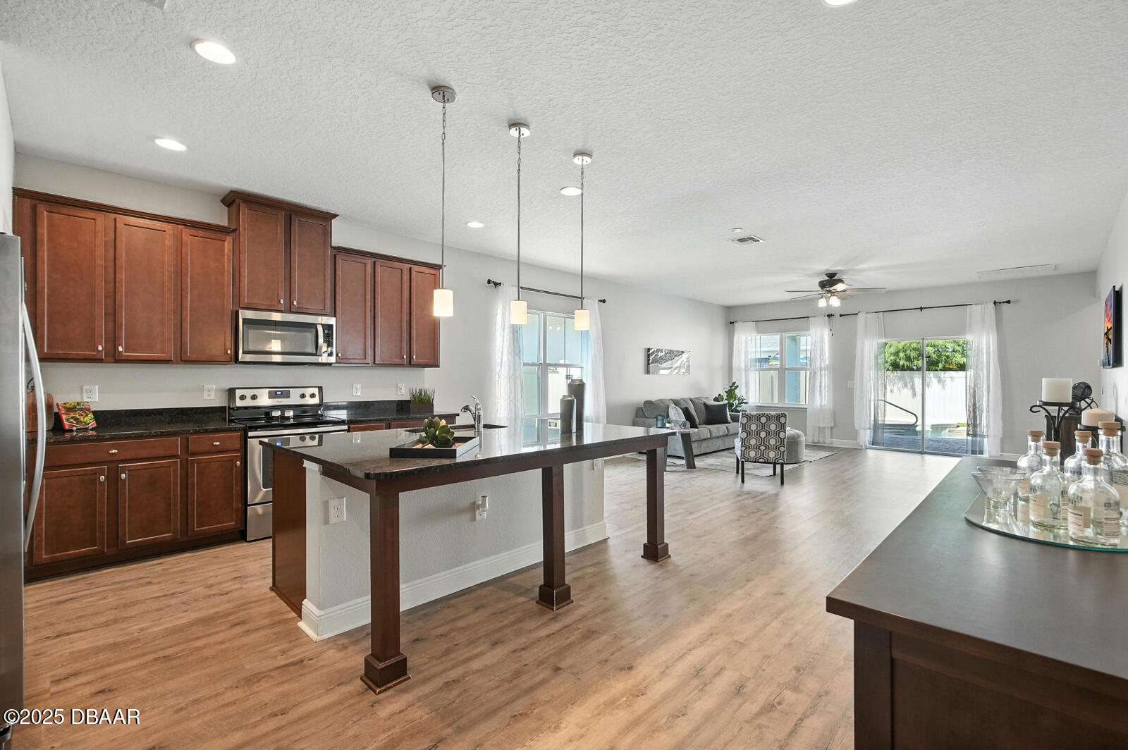 5428 Estero Loop Port Orange, FL 32128 - Photo 11 of 41 a kitchen with lots of counter top space a stove a dining table and chairs
