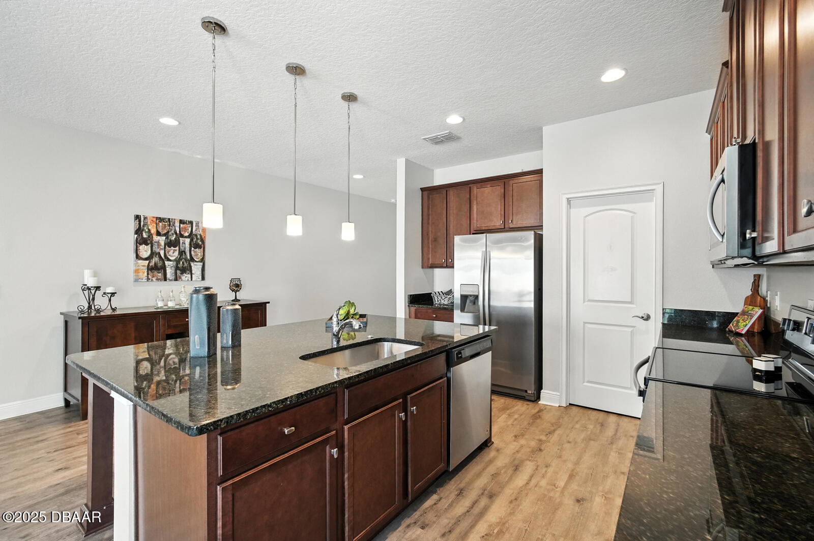5428 Estero Loop Port Orange, FL 32128 - Photo 12 of 41 a kitchen with stainless steel appliances granite countertop a sink refrigerator and cabinets