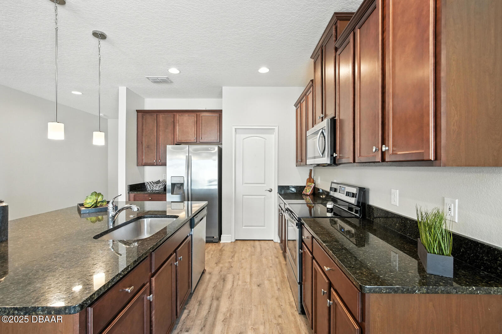 5428 Estero Loop Port Orange, FL 32128 - Photo 13 of 41 a kitchen with stainless steel appliances granite countertop a sink stove and refrigerator