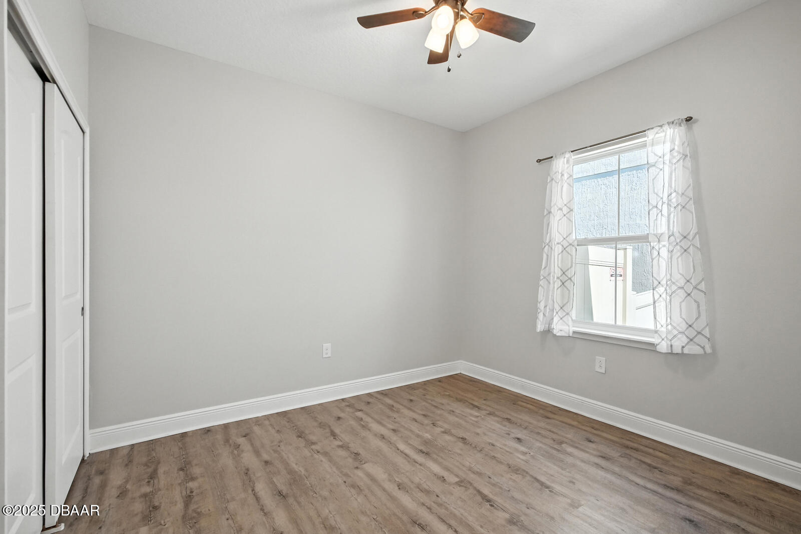 5428 Estero Loop Port Orange, FL 32128 - Photo 21 of 41 wooden floor in an empty room with a window