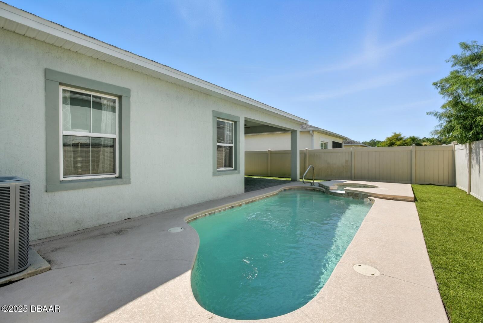 5428 Estero Loop Port Orange, FL 32128 - Photo 33 of 41 a view of a backyard with a barbeque grill and plants