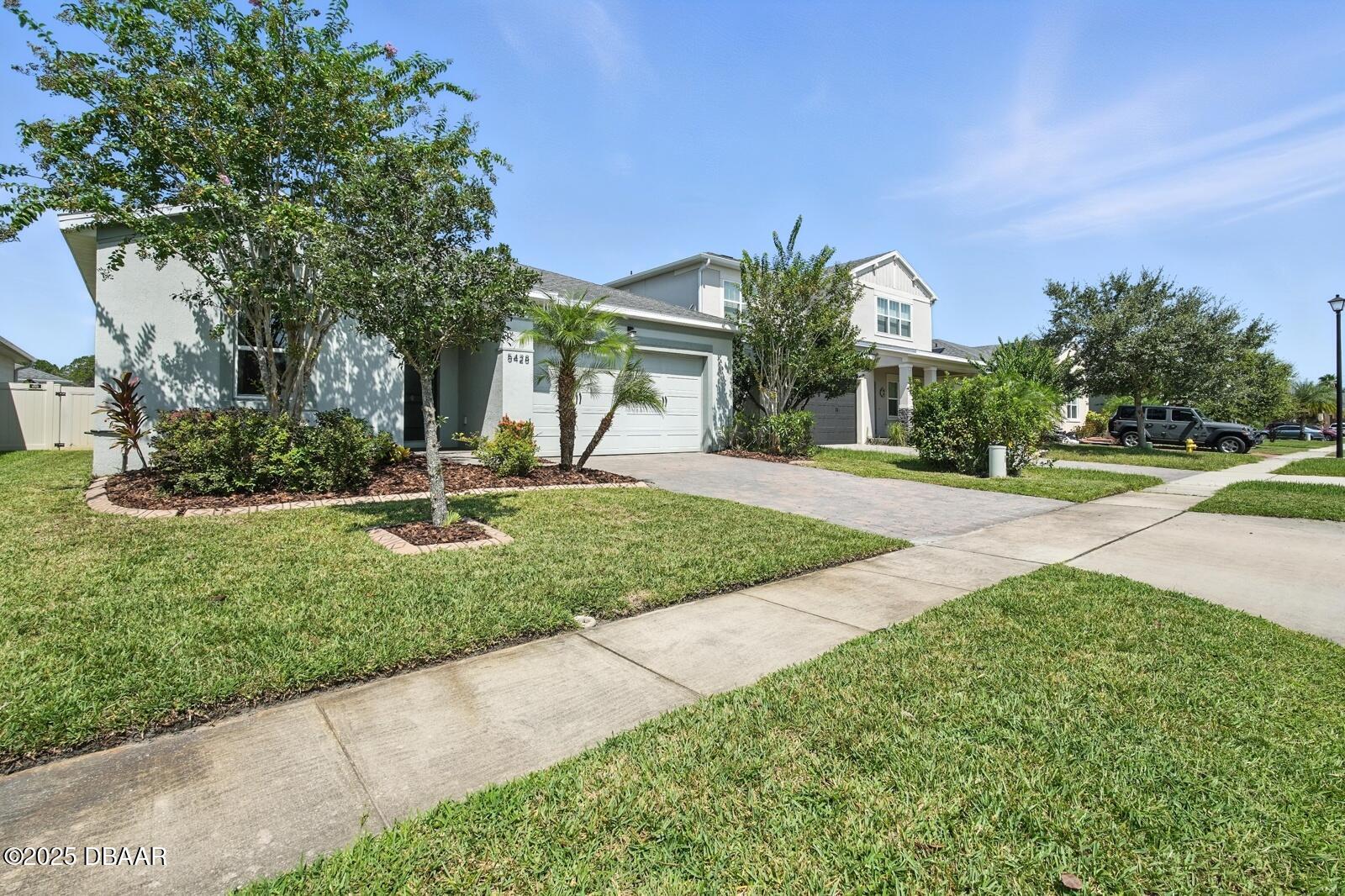 5428 Estero Loop Port Orange, FL 32128 - Photo 4 of 41 a front view of a house with a yard
