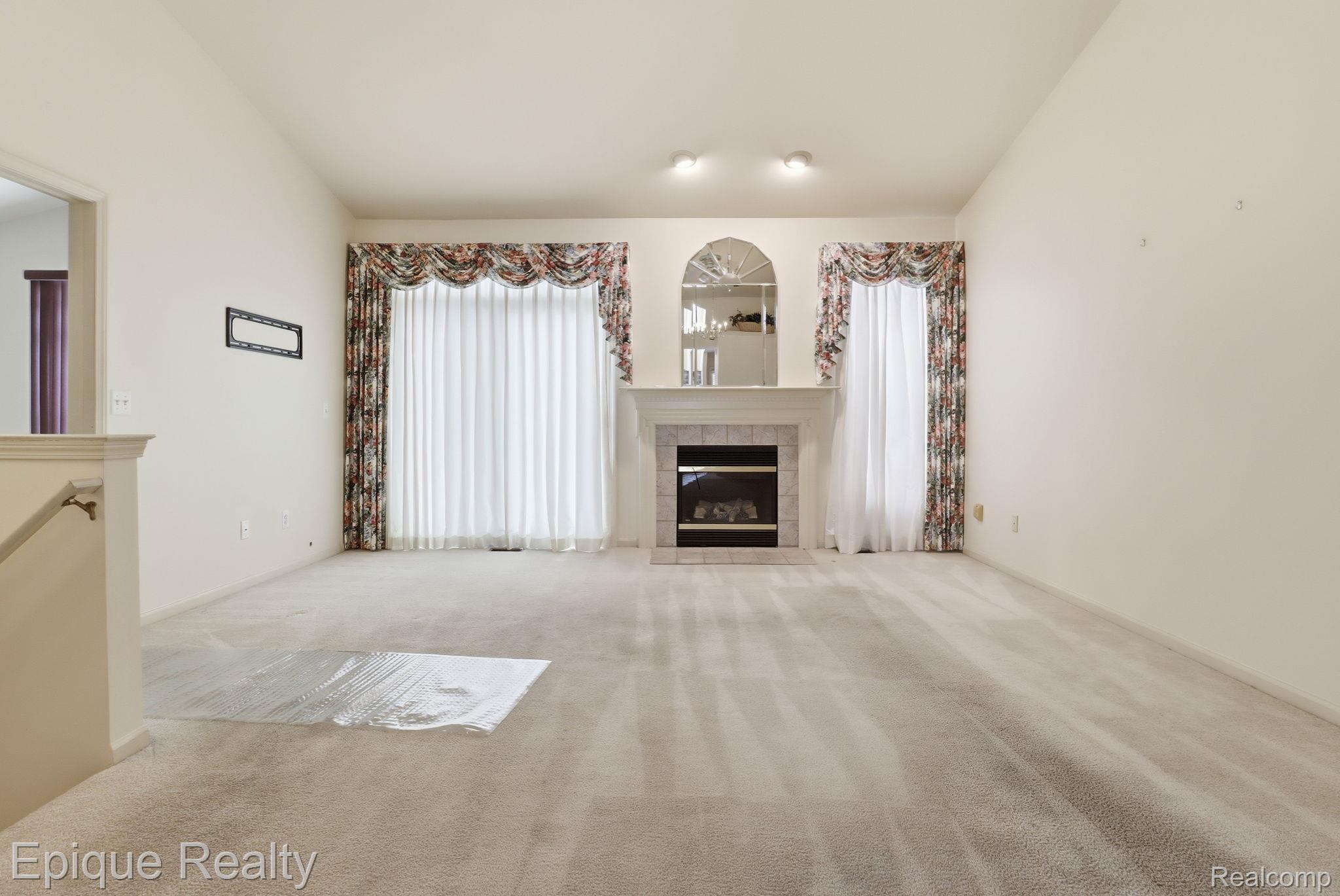 321 Cherry Grove Road Canton, MI 48188 - Photo 4 of 22 Unfurnished living room with carpet, a fireplace, and lofted ceiling