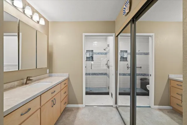 a bathroom with a shower and mirror