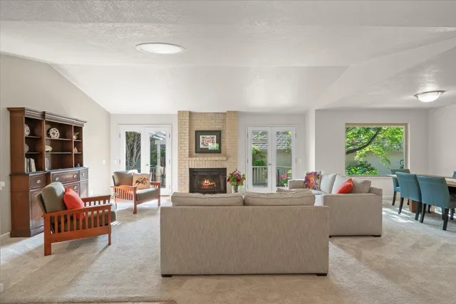 a living room with furniture and large windows