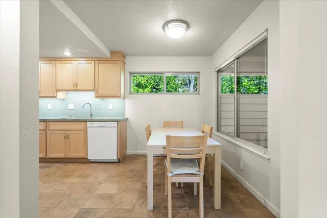 a large kitchen with stainless steel appliances granite countertop a lot of counter space and a sink