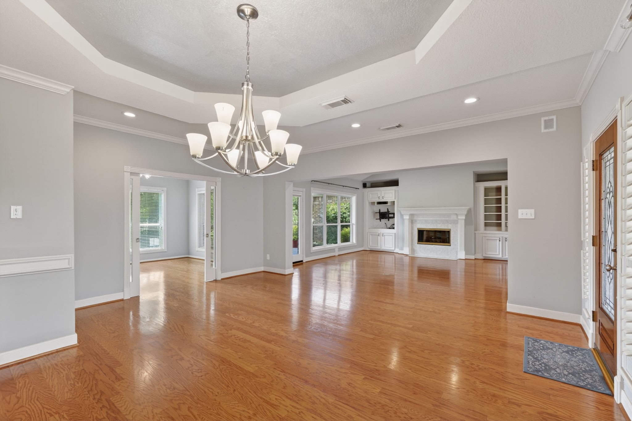 20714 Flora View Court Spring, TX 77379 - Photo 11 of 40 a view of an empty room with wooden floor and kitchen view