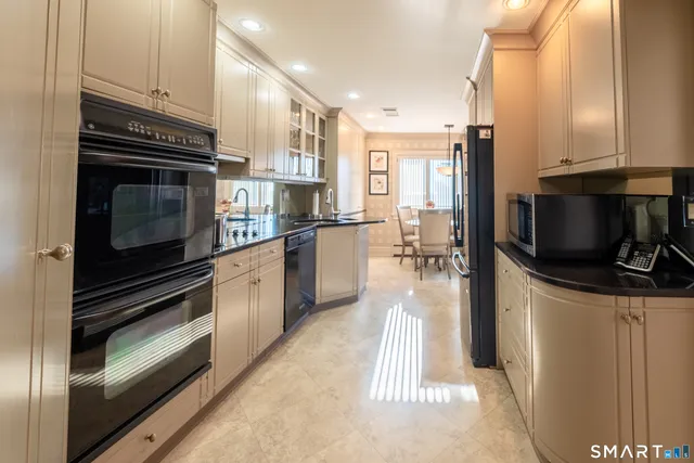 a bedroom with a bed and a dresser with chair