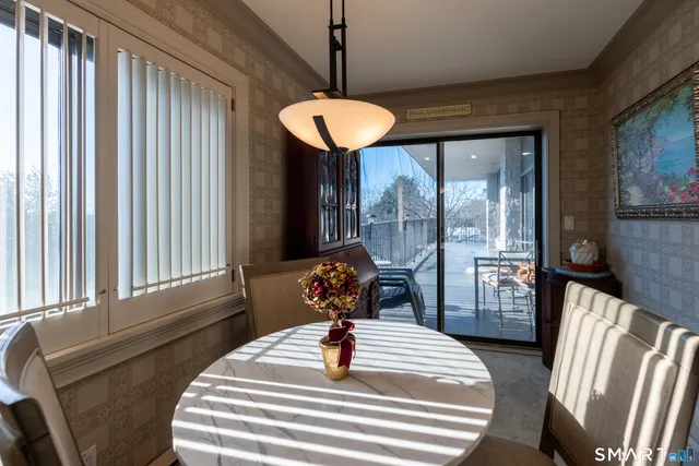 a view of a hallway with kitchen and refrigerator