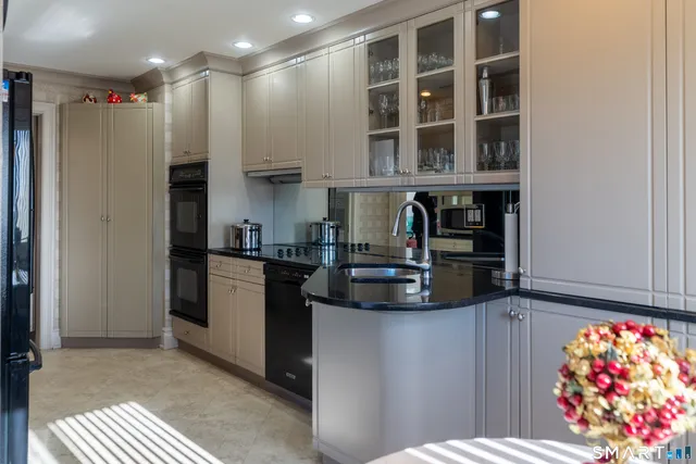 a bathroom with a double vanity sink and mirror with shower