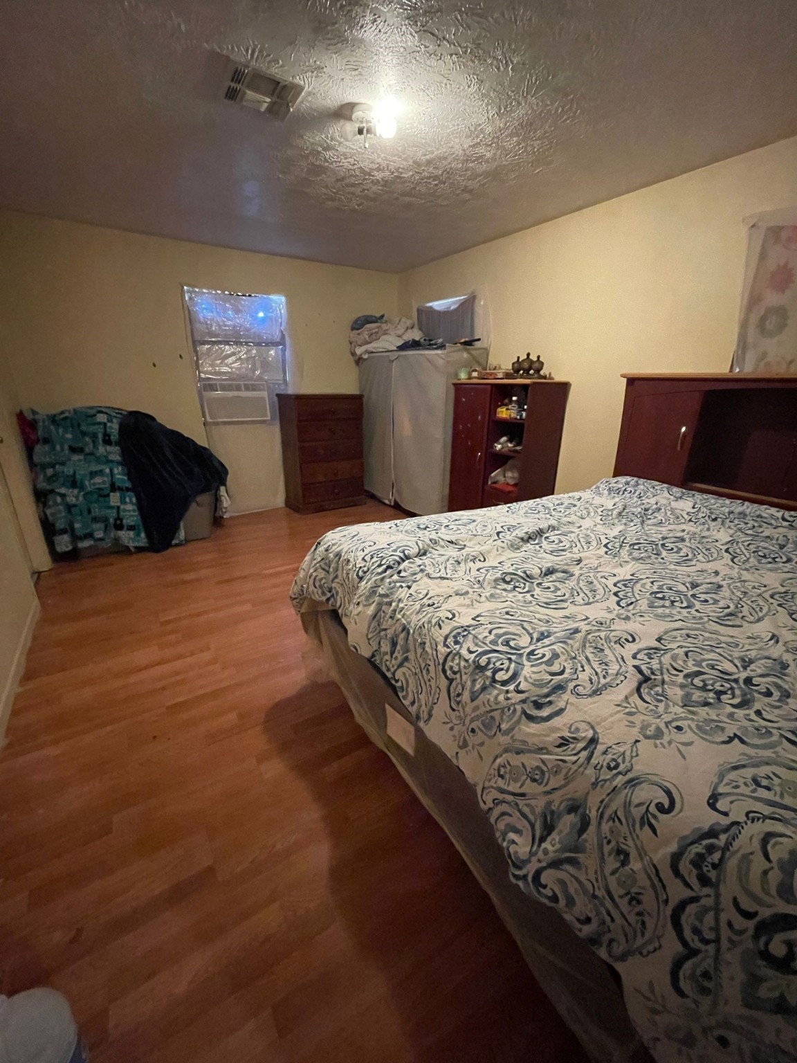 26113 Tyler Park Road Bedias, TX 77831 - Photo 13 of 18 a bedroom with a bed and wooden floor