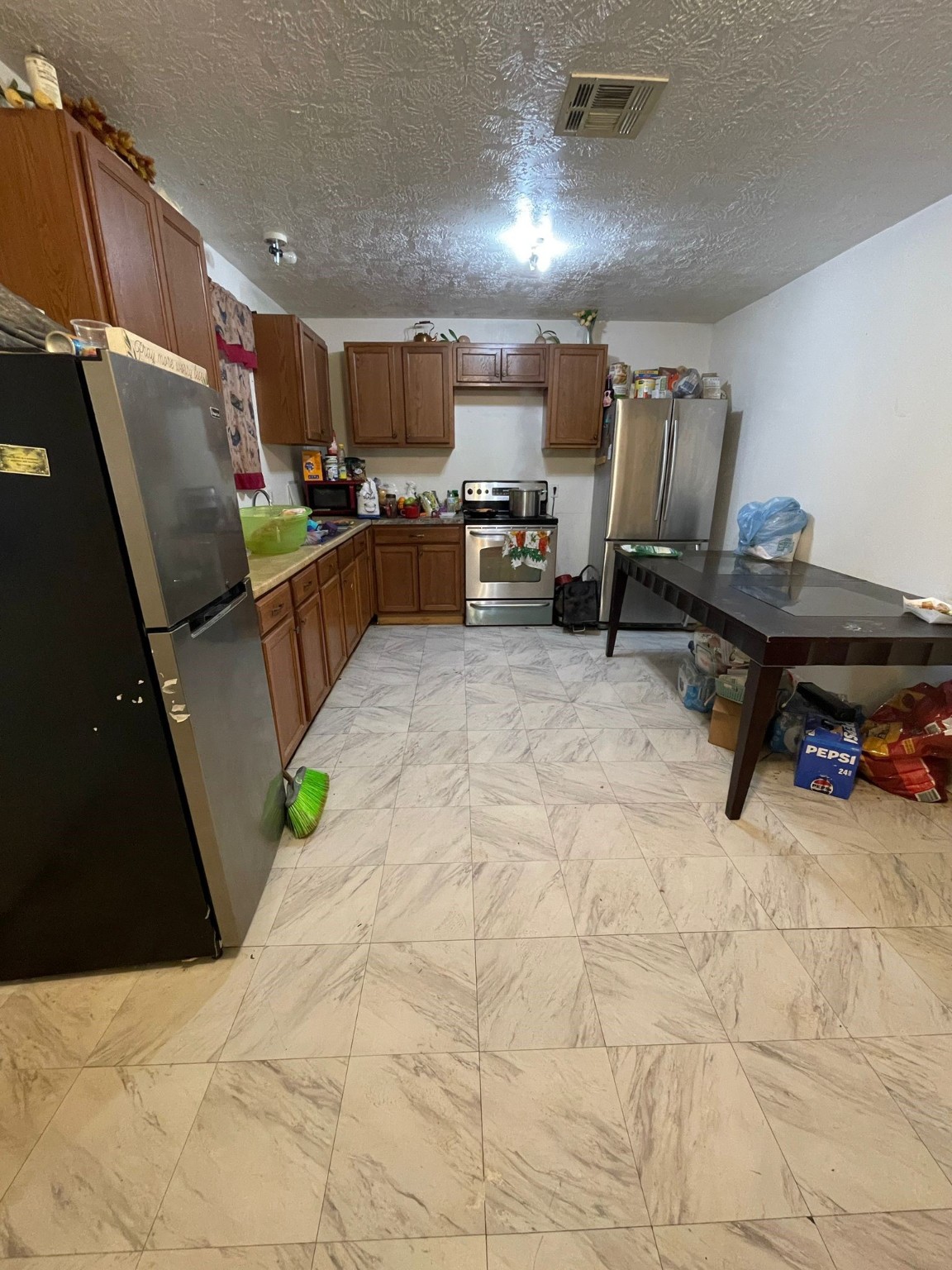 26113 Tyler Park Road Bedias, TX 77831 - Photo 7 of 18 a kitchen with stainless steel appliances kitchen island granite countertop a refrigerator and a sink