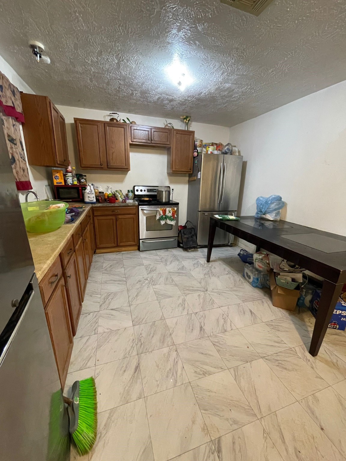 26113 Tyler Park Road Bedias, TX 77831 - Photo 10 of 18 a kitchen with stainless steel appliances kitchen island granite countertop a refrigerator and stove