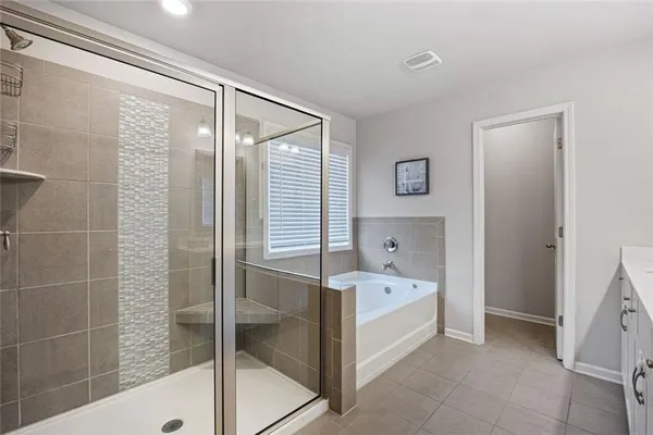 a bathroom with a bathtub and a shower