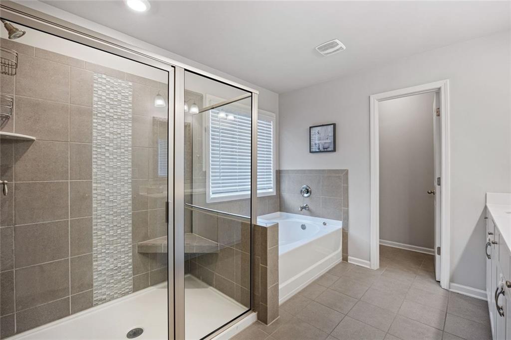 641 Little Bear Loop Canton, GA 30114 - Photo 19 of 37 a bathroom with a bathtub and a shower