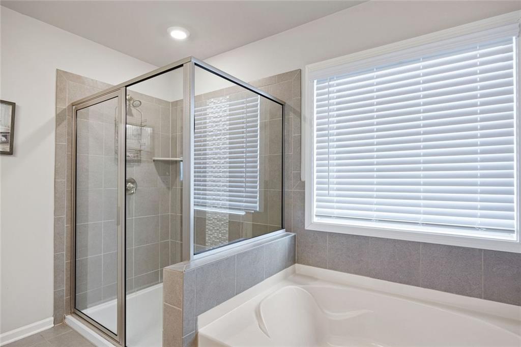 641 Little Bear Loop Canton, GA 30114 - Photo 20 of 37 a bathroom with a bathtub and a shower