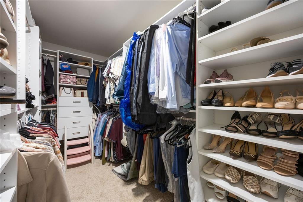641 Little Bear Loop Canton, GA 30114 - Photo 21 of 37 a view of walk in closet with clothes and shoes