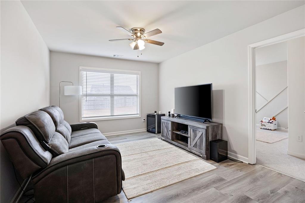 641 Little Bear Loop Canton, GA 30114 - Photo 22 of 37 a living room with furniture and a flat screen tv