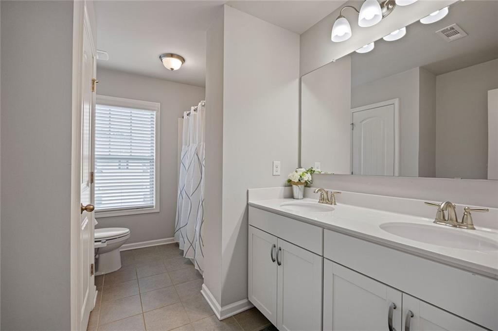 641 Little Bear Loop Canton, GA 30114 - Photo 25 of 37 a bathroom with a sink a toilet and a mirror