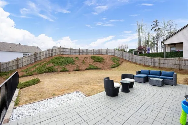a view of roof deck with lawn chairs and wooden fence