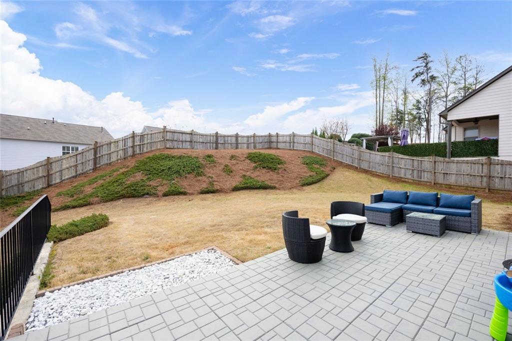 641 Little Bear Loop Canton, GA 30114 - Photo 28 of 37 a view of roof deck with lawn chairs and wooden fence