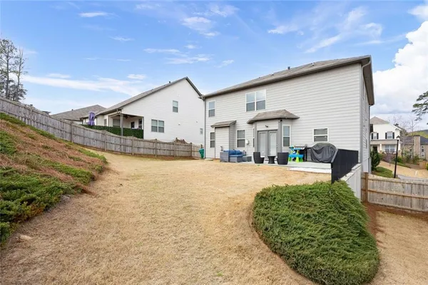 a view of a house with backyard swimming pool and sitting area
