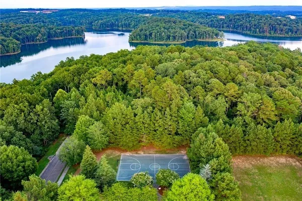 an aerial view of a house with a yard and lake view