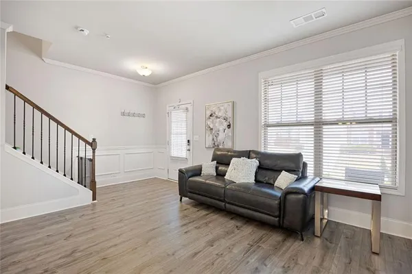 a living room with furniture and wooden floor