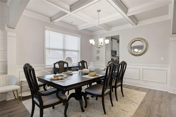 a view of a dining room with furniture and chandelier