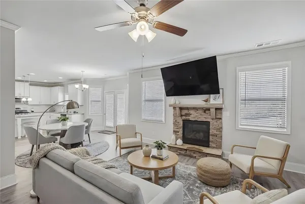 a living room with furniture a fireplace and a flat screen tv