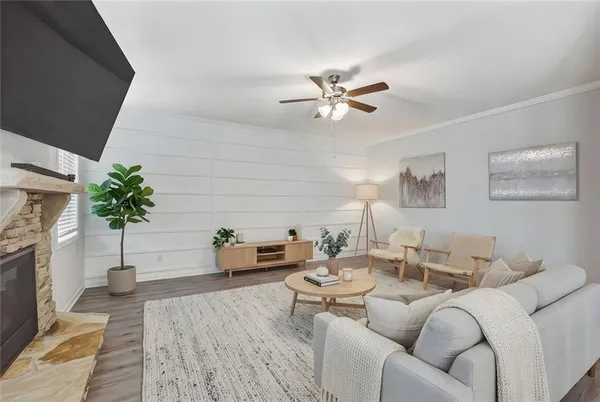 a living room with furniture a fireplace and a potted plant