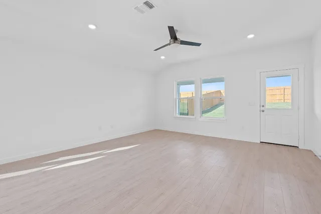 an empty room with windows and closet