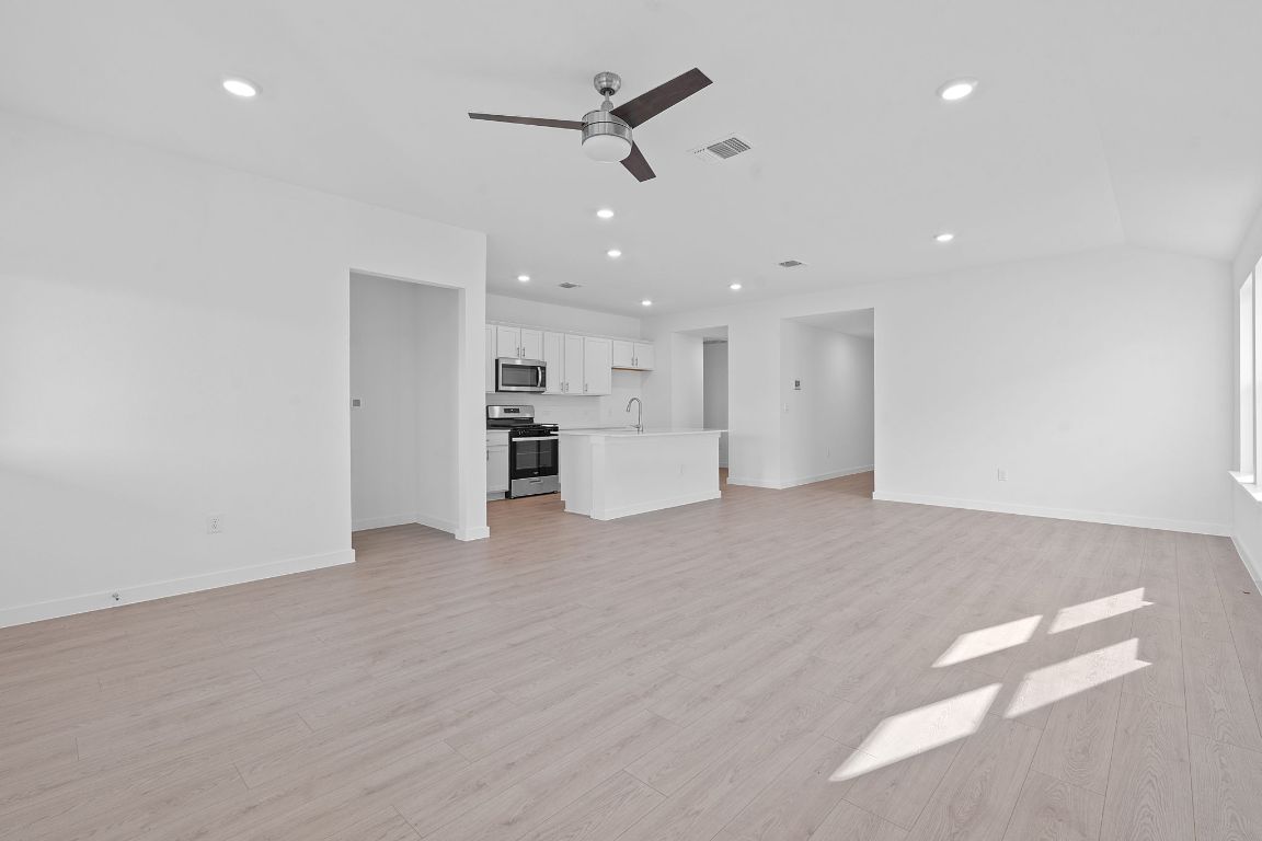 9701 Oxbow Strap Drive Austin, TX 78724 - Photo 14 of 34 Unfurnished living room featuring recessed lighting, a ceiling fan, and light wood finished floors