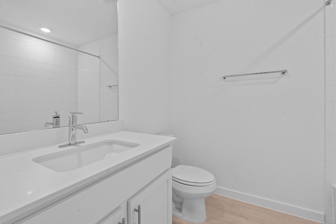 9701 Oxbow Strap Drive Austin, TX 78724 - Photo 26 of 34 Bathroom featuring light wood-type flooring, vanity, and a shower