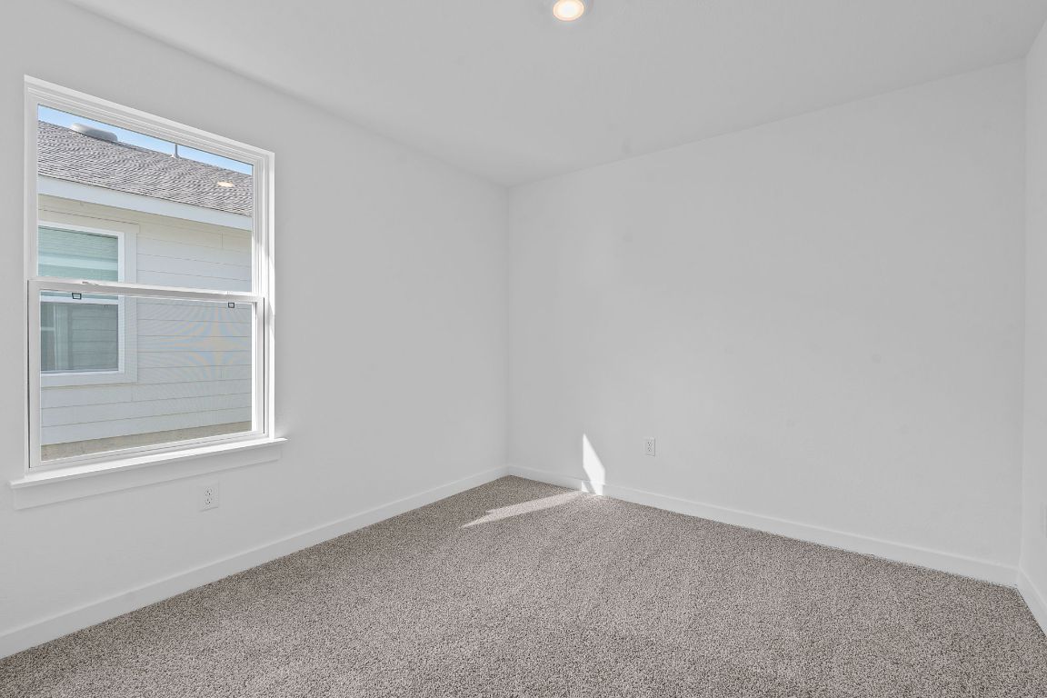 9701 Oxbow Strap Drive Austin, TX 78724 - Photo 27 of 34 Spare room featuring carpet flooring and baseboards