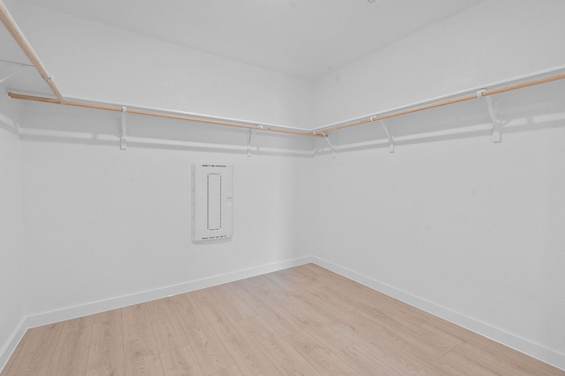 9701 Oxbow Strap Drive Austin, TX 78724 - Photo 28 of 34 Spacious closet featuring light wood-style floors and electric panel