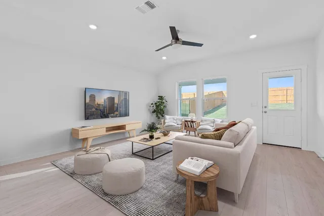 a living room with furniture and a large window